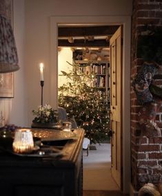 a living room with a christmas tree in the corner