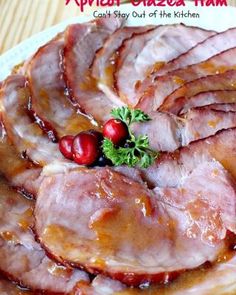 sliced ham on a plate with cranberries and parsley