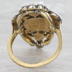 An original antique Georgian style diamond ring circa 1850's. This delightful treasure reflects light beautifully. The diamonds are foil backed set in a silver top and gold bottom. This item has no sign of change or repair. Details: SIZE: 4 Antique Diamond Ring Silver Top / Gold Bottom Original Condition No Sign Of Change Or Repair Foil Backed Diamonds Total Carat Weight: Approx. 3 carats Center Oval Diamond Total Carat Weight: 2 carats 4 Marquise = 0.40ct /4Round=0.45 /4Round=0.20ct /6Round=0.1 Antique Cluster Ring With Rose Cut Diamonds, Antique Cluster Ring With Diamond Accents, Vintage Oval Engraved Diamond Ring, Vintage Engraved Oval Diamond Ring, Antique Diamond Signet Ring With Rose Cut, Antique Diamond Signet Ring With Rose Cut Diamonds, Victorian Wedding Signet Ring With Rose Cut Diamonds, Antique Hallmarked Diamond Ring, Victorian Diamond Ring With 17 Jewels