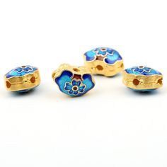 four blue and gold bead caps with flowers on them