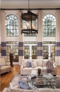 a living room with two couches and a chandelier