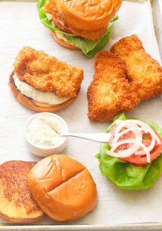 chicken sandwich with lettuce, tomato and mayonnaise served on buns