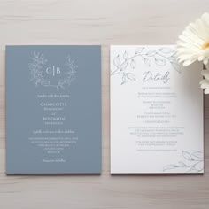 the wedding stationery is laid out next to a flower