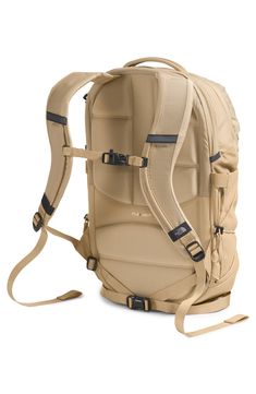 a beige backpack with straps on the front and back ends, sitting upright against a white background