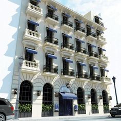 a large white building with balconies and windows