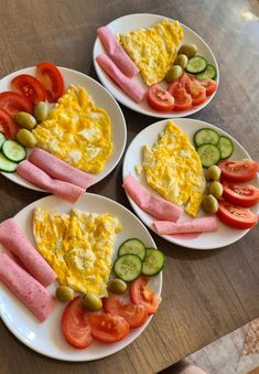 three plates with different types of food on them sitting on a wooden table next to each other