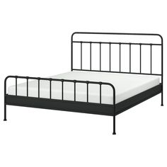 a black metal bed frame with white sheets