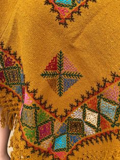 Beautiful poncho hand-woven in a backstrap loom and cross stitch hand-embroidered Color: Mustard, colorful embroidery Fits ONE SIZE Handwoven Poncho Shawl For Festivals, Handwoven Festival Poncho Shawl, Bohemian Handwoven Shawl Poncho, Bohemian Shawl With Floral Embroidery For Festival, Bohemian Floral Embroidered Shawl For Festival, Bohemian Kaftan With Multicolor Embroidery And Woven Motifs, Fall Folk Embroidered Poncho, Bohemian Handmade Poncho Cape, Bohemian Embroidered Festival Poncho