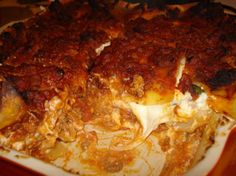 a close up of a plate of lasagna casserole with meat and cheese