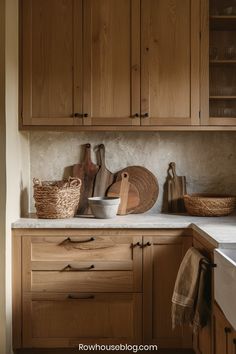 a kitchen with wooden cabinets and baskets on the counter top, along with other utensils