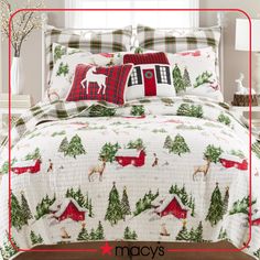 a christmas themed bed set with red and white plaid pillows, deers and trees