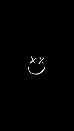 a smiley face drawn in the dark with two crosses on it's forehead and eyes closed