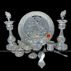 an assortment of silver items on a black background