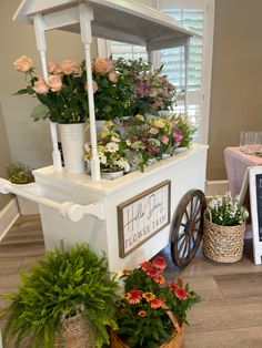 a flower cart with potted flowers on top