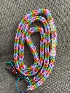 Rainbow loom fishtail design in sparkle rainbow lanyard keychain and badge/ID holder. Keychain is rainbow - split ring and lobster claw. Optional charms available. Lanyard colors and length are customizable.  Name beads are white with gold lettering. Please reach out if interested in other bead colors (see photos). Pricing includes badge holder - as shown in example photo. Loom Lanyard, Cute Multicolor Lanyards As Gift, Multicolor Lanyards With Key Leash As Gift, Multicolor Lanyard With Key Leash As Gift, Multicolor Lanyards With Key Leash For Personal Use, Personalized Multicolor Lanyards For Personal Use, Rainbow Beaded Lanyard, Rainbow Loom Fishtail, Personalized Multicolor Lanyards