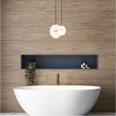 a large white bath tub sitting next to a wall mounted light above it's head