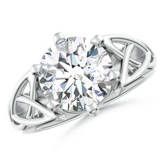 a white gold ring with a diamond in the center and an intricate design on it