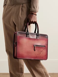 Berluti's briefcase is worth the investment. Crafted in Italy from smooth Venezia leather, it's debossed with the label's 'Scritto' calligraphy and has a zipped pocket at the front to keep your cardholder close. The structured shape is the ideal size for a tablet or portfolio. Attach the shoulder strap when navigating a busy commute. Business Bags Men, Leather Briefcase Bag, Fall White, Leather Briefcase Men, Latest Bags, Briefcase For Men, Business Bag, Leather Briefcase, Leather Messenger Bag