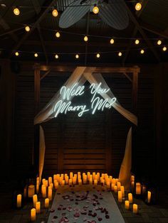 a lighted sign that says welcome to merry time surrounded by candles