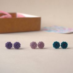 A mat ✨ set of small beaded earrings that can be worn every day. The set includes the following colors: - purple; - dusty pink; - dark green. The earrings are made of miniature Japanese beads. The metal base is stainless steel. The approximate diameter of one earring is 7-8 mm (0.27-0.31 in). A wonderful gift for any event to a wife, sister, friend💕 Please note❗️ The color rendering of the product may differ due to different settings of the displays. Hypoallergenic Purple Beaded Earrings, Purple Earrings With Tiny Beads For Gift, Handmade Minimalist Purple Earrings, Small Beaded Earrings, Violet Rose, Japanese Beads, Colors Purple, Pink Dark, Color Rendering