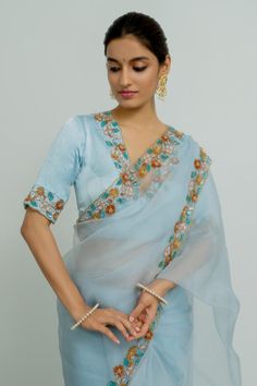 Powder blue silk organza saree with floral and sequins hand embroidered borders. Comes with a blouse.
Components: 2
Pattern: Hand embroidered
Type Of Work: Floral, Sequins
Neckline: Deep V Neck
Sleeve Type: Half
Fabric: Silk organza
Color: Blue
Other Details: 
Disclaimer : The product will dispose off some color, since it is hand dyed.
Occasion: Wedding - Aza Fashions Lotus Saree, Powder Blue Color, Add Sleeves, Border Saree, Blue Saree, Organza Saree, Silk Organza, Saree With Blouse, Blue Silk