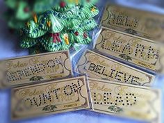 some type of business cards sitting next to each other on a blue table with green decorations