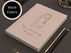 a notebook with an image of a woman's face and the words, more colors on it