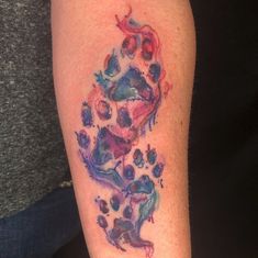 a person with a tattoo on their arm has a dog paw print in the shape of a heart