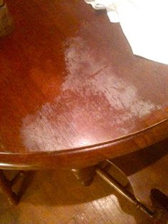 a wooden table that has been stained brown with white paint on it and the edge of the table is missing