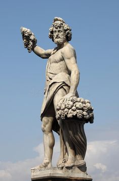 an ancient statue with flowers in his hand