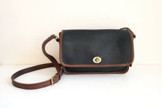 "Coach Spectator Compartment Shoulder bag in black leather with British tan accent.  This vintage Coach bag is high quality featuring a spacious interior, flap turn lock closure, front pocket, back slip pocket, and small interior compartment with zipper. The Coach Compartment Shoulder bag has been throughly cleaned, reshaped, and conditioned.  In good condition with light wear and minor imperfections. Imperfections include wear on the piping and exterior wear on the leather - please review all p Black Leather Satchel With Turn-lock Closure, Classic Flap Bag With Brass Hardware For Work, Classic Rectangular Flap Bag With Leather Trim, Formal Flap Bag With Leather Trim, Classic Crossbody Flap Bag With Leather Handles, Classic Rectangular Saddle Bag With Leather Trim, Black Satchel With Turn-lock Closure For Everyday, Black Everyday Satchel With Turn-lock Closure, Classic Crossbody Satchel With Leather Trim