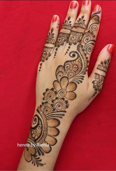 a woman's hand with henna tattoos on it