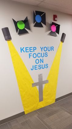 a bulletin board with the words keep your focus on jesus written in blue and yellow