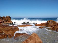 some rocks and water on the beach