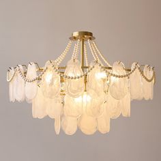 a chandelier with several glass pieces hanging from it's arms and two lights on each side