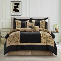 a bed with black and tan comforters in a room