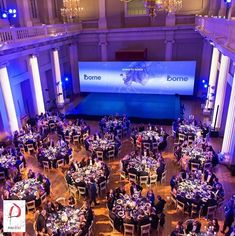 an overhead view of a banquet hall with round tables and chandeliers