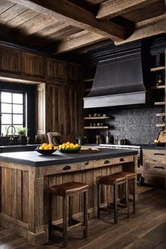 a kitchen with wooden floors and black counter tops, an island in the middle is surrounded by two stools