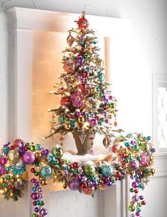 a decorated christmas tree sitting on top of a mantle