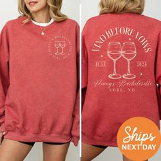 a woman wearing a red sweatshirt with wine glasses on it