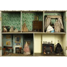 a doll house with furniture and dolls in it