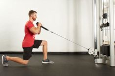 a man is squatting with a pull rope