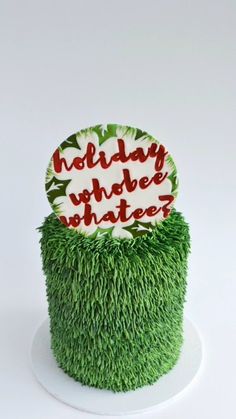 a green cake with white frosting and red lettering on top that says holiday viber whatever