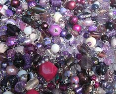 many different colored beads are grouped together