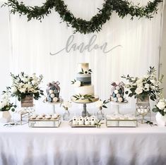 a table topped with lots of cakes and desserts