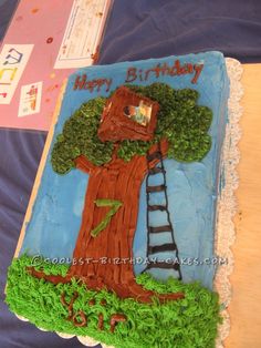 a birthday cake with a tree and ladder on it