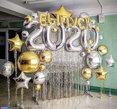 balloons and streamers in the shape of numbers are displayed at an entrance for a new year's eve celebration