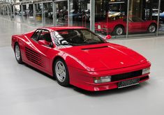 a red sports car parked in a garage