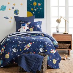 a child's bedroom with space themed bedding