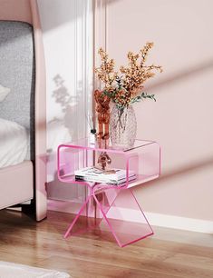 a pink side table next to a bed